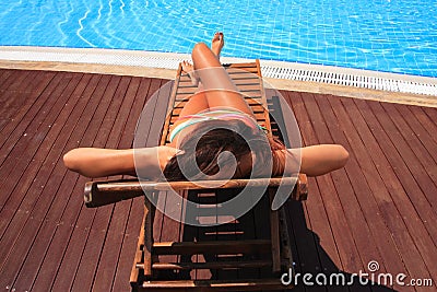 Beautiful young woman at a pool