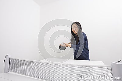 Beautiful young woman preparing to serve table tennis ball