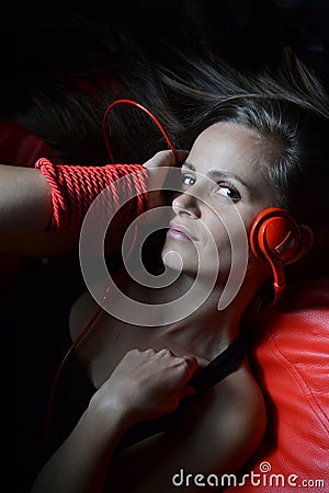 A beautiful young woman with the red headphones