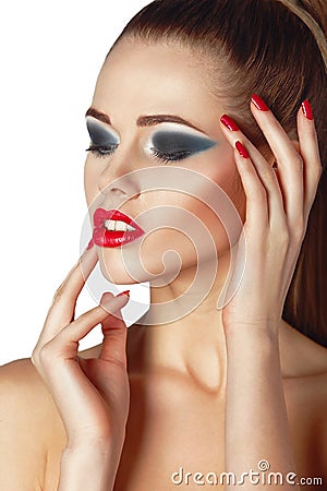 Beautiful young woman with red lips and nails