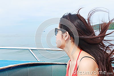 A beautiful young woman relaxing on speed boat