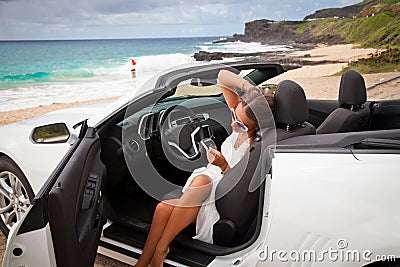 Beautiful young woman resting in her car