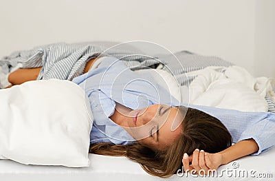 Beautiful young woman sleeping in bed