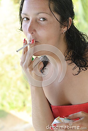 Beautiful young woman smoking cigarette