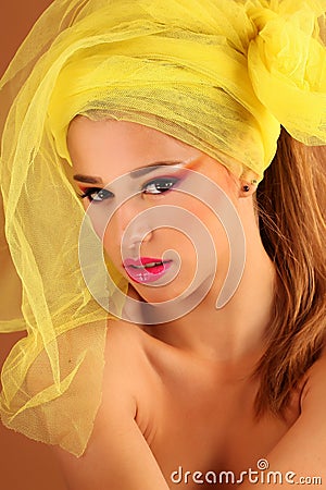 Beautiful young woman in the studio, wearing colorful make up