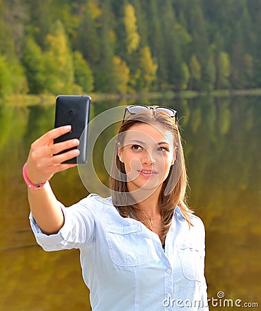 Beautiful young woman taken picture of herself, selfie