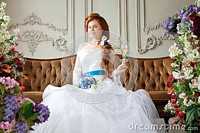 Beauty bride in a luxurious interior with flowers