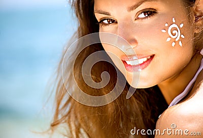 Beauty Girl with Sun Tan Cream on her Face