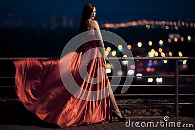 Beauty Woman In Fluttering Red Dress Outdoor