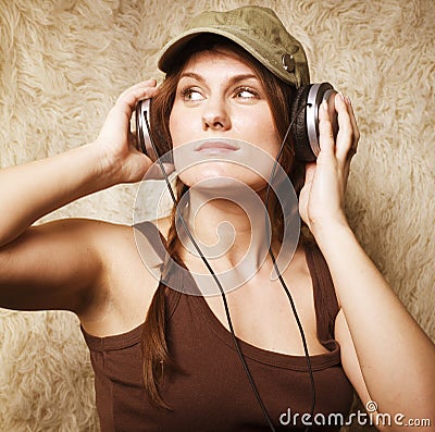 Beauty young girl listening music in headphones