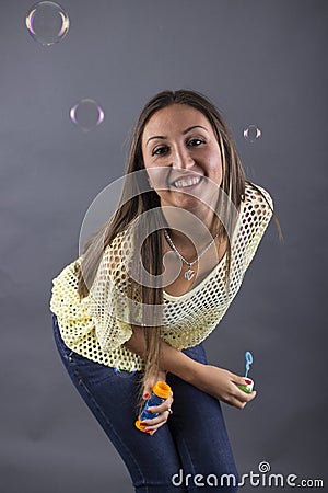 A beauty young woman blowing soap bubbles