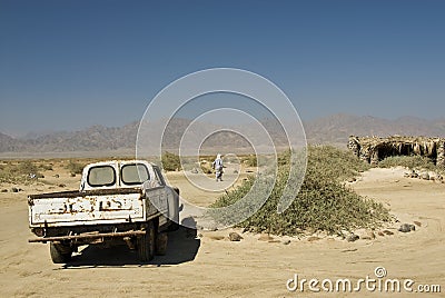 Bedouin man walking away from his truck.