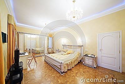 Bedroom with beautiful bed, tv, mirrorlike wardrob