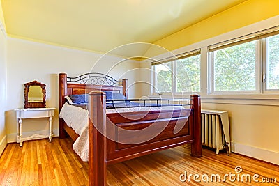 Bedroom with ots of windows and wood floor.