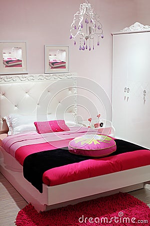 Bedroom with white wardrobe and pink carpet.