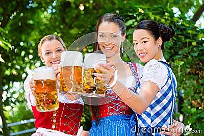 Beer garden - friends in traditional clothes in bavaria