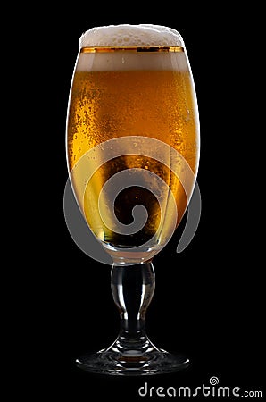 Beer into glass on a black