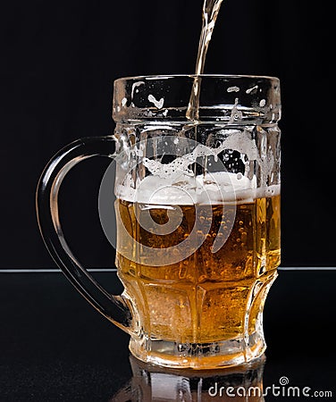 Beer pouring in a mug