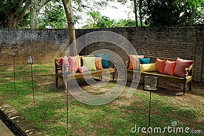 Benches with cushions in garden