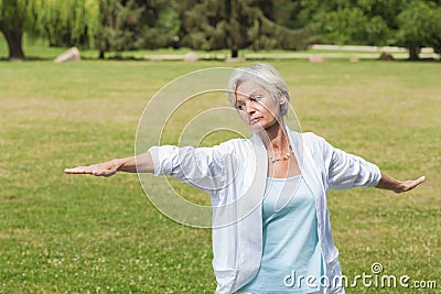 Best ager women practising yoga ant tai chi