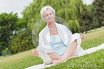 Best ager women practising yoga ant tai chi