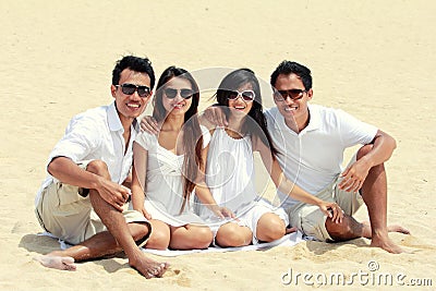 Best friend in white having fun laughing together at the beach