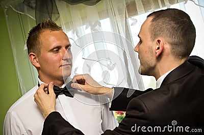 Best man dressing groom
