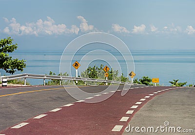 Bicycle lane on curve road along the beach with Traffic sign