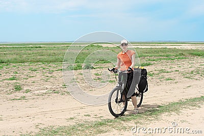 Bicycle tourist girl standing on road