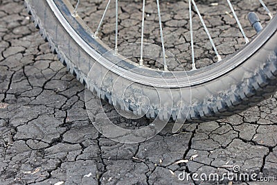 Bicycle wheel on cracked earth