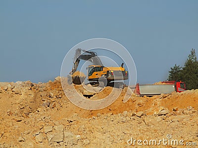 Big black orange digger in open sand mine is waiting for new shift.