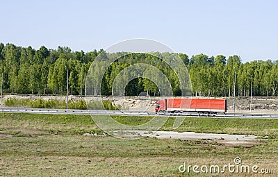 Big red truck shot from far away