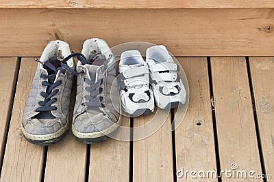 Big and small shoes on the back deck