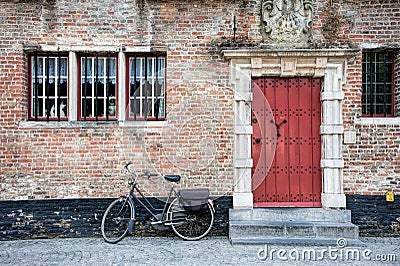 Bike outside building with red door