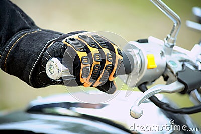 Biker hand rests on the steering wheel motorcycle