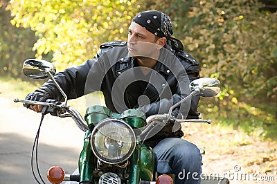 Biker man sits on a bike