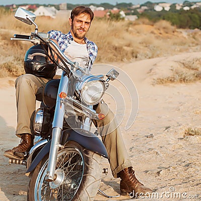 Biker man sits on a bike