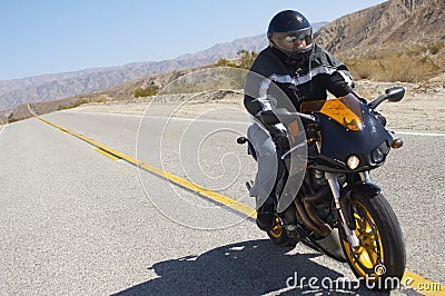 Biker Riding Motorcycle On Road