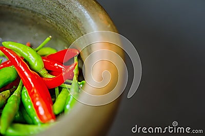 Red and green pepper in mortar