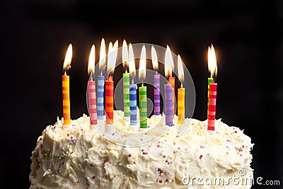 Birthday cake and candles on black background