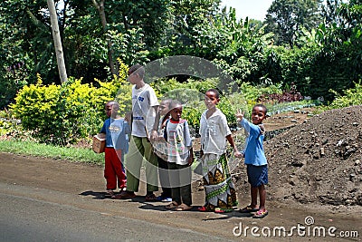 Black African children crossing road, Tanzania.