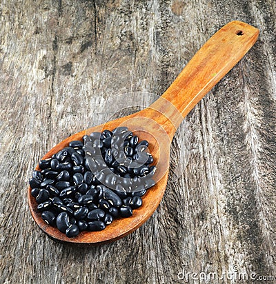 Black beans in wooden spoon