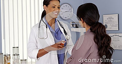 Black doctor explaining prescription medicine to patient