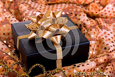 Black gift box with gold ribbon.