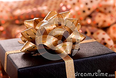 Black gift box with gold ribbon.