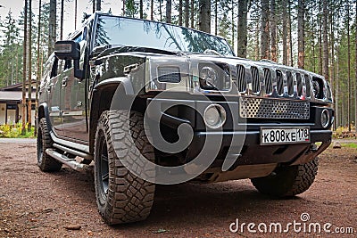 Black Hummer H2 car stands on dirty country road