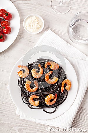 Black pasta with shrimps food on light background