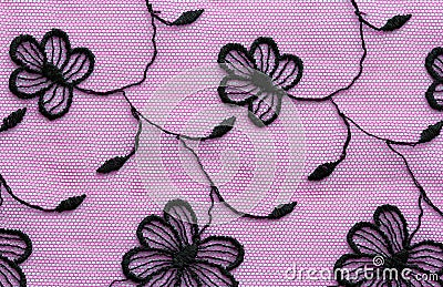 Black on pink flowers lace material texture macro shot