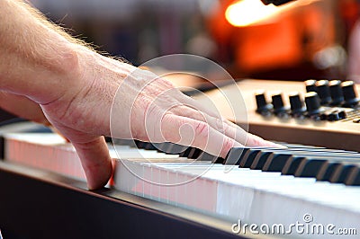 Black and white piano keys with hand