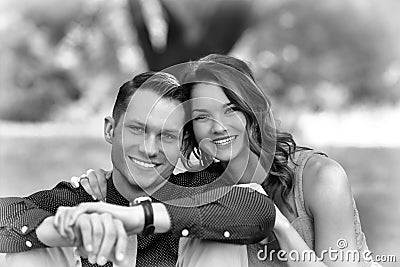 Black and White version of a happy young couple posing seated on